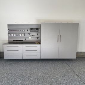 Custom storage cabinets in Silver Frost, Silver slat wall, Ebony Star countertop and Comet epoxy floors.