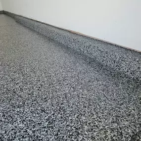 Upgrade your garage with cutting-edge polyspartic flooring, Graphite color shown! Say goodbye to stains and hello to unmatched durability and style.