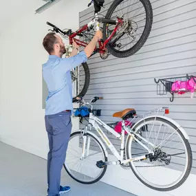 No more garage chaos! Our personalized garage storage makes cleanup a breeze, like this slat wall.