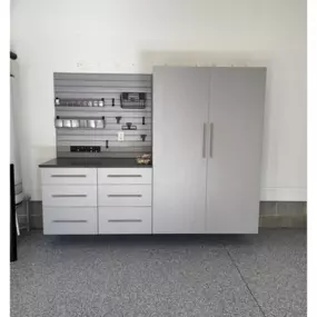 Custom storage cabinets in Silver Frost, Silver slat wall, Ebony Star countertop and Comet epoxy floors.