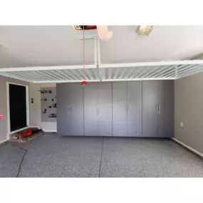 Garage makeover  with custom cabinets, epoxy floor, overhead storage and slat wall.