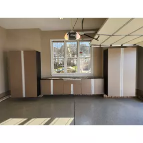 Garage storage with custom cabinets in Shadow Frost with extruded handles and Ebony Star counter tops. It turned out fantastic for our Monroe, NC client.