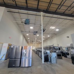 appliance showroom floor with kitchen and home appliances on display