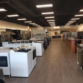 appliance showroom with multiple washing machine appliances on display