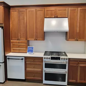 kitchen showroom with appliances on display and wooden cabinetry