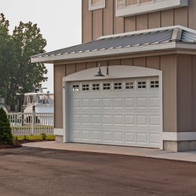 CHI Garage Door, Short Raised Panel door in white with optional Stockton window inserts.