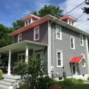 new Certainteed siding and trim with new gutters and downspouts.