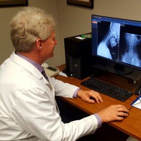 Dr. Eric Ribenbom looking at Xrays at  Shelbyville Chiropractic and Rehab Center