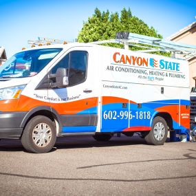 Canyon State install trucks parked in front of a customer house