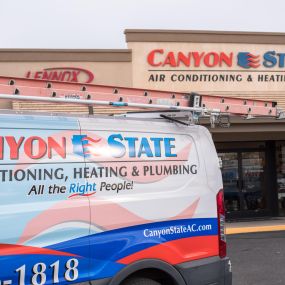 Canyon State service trucks parked in front of the building