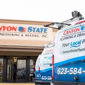 Canyon State company vehicles parked in front of the building