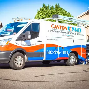 Canyon State install trucks parked in front of a customer house