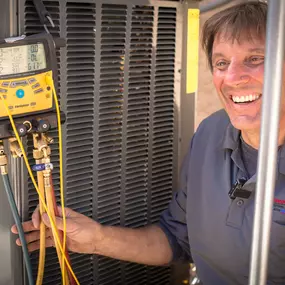 Canyon State team member performing final checks on newly installed HVAC equipment