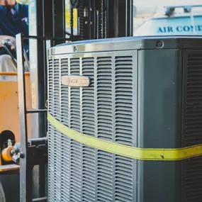 HVAC equipment strapped to a forklift