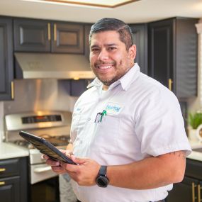 A plumber getting information ready for a maintenance call in the North Dallas Denton area.