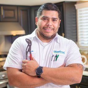 Plumber holding a tool working on drain service in the Dallas Carrollton area.