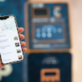 A CoinFlip Bitcoin ATM with display screen, QR camera reader and cash intake slot against a white background.