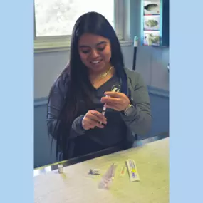 An Animal Health Care Denver team member drawing up vaccines