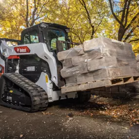 Bobcat Construction Compact Truck Loader with Pallet Fork Attachment Moving Bricks