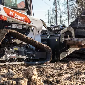 Bobcat industrial grapple attachment lifts large chunks of concrete.