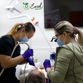 The team of skilled dentists performing cavity checkup on a patient