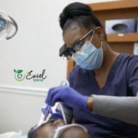 Dentist treating a patient at Excel dental