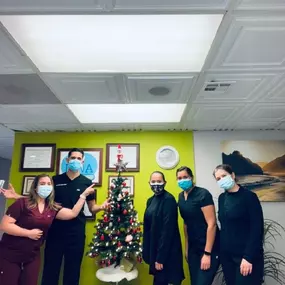 Dr Dino celebrating christmas with his colleagues in his dental office