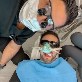 Dr Sam Harouni with his patient in his dental office
