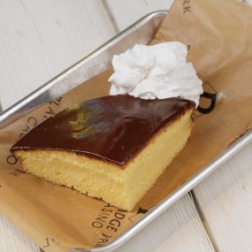 A mouthwatering slice of Boston cream pie, a classic New England dessert served at the Sportsbook Restaurant and bar at Plainridge Park Casino in Plainville, Massachusetts.