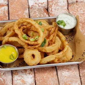 Crispy beer battered onion rings, serrano ranch & honey mustard served at the Sportsbook restaurant and bar at Plainridge Park Casino in Plainville, Massachusetts.