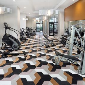 24-hour athletic club with strength training equipment at Camden Atlantic apartments in Plantation, Florida.