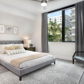 Bedroom with lighted ceiling fan at Camden Atlantic apartments in Plantation, Florida.