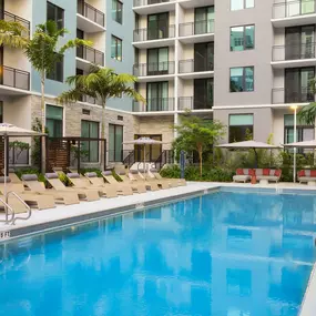 Pool at dusk with cabanas at Camden Atlantic apartments in Plantation, Florida.