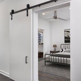 Studio apartment with sliding barn door at Camden NoDa Apartments in Charlotte, NC