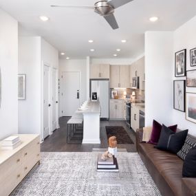 Natural Modern Finish living room with adjacent kitchen and luxury vinyl plank flooring throughout at Camden NoDa in Charlotte North Carolina