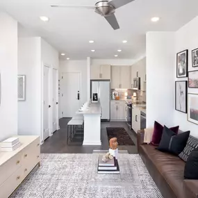 Natural Modern Finish living room with adjacent kitchen and luxury vinyl plank flooring throughout at Camden NoDa in Charlotte North Carolina