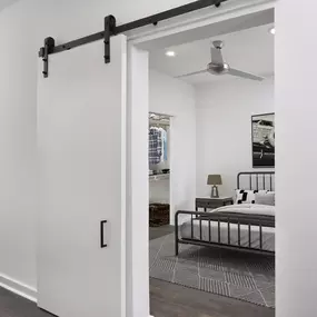 Studio apartment with sliding barn door at Camden NoDa Apartments in Charlotte, NC