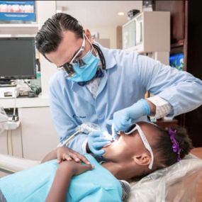 Dr. patel working on a patient for smile forever atlanta