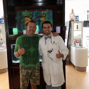 Dr. patel smiling with happy client