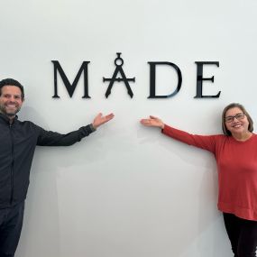 Dr. Pallotto and patient in front of the MADE logo