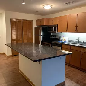 Building 6 Kitchen with Island and stainless steel appliances