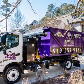 count junkula of raleigh branded dumpster in driveway
