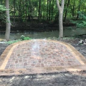The different types of hardscapes we create are block retaining walls, Boulder Walls, stone patios, dry streams, fire pits, flagstone patios, free-standing walls, natural stone walkways, paver walkways, patios and driveways, outdoor kitchens, steps, stone retaining walls and steps, and timbers.