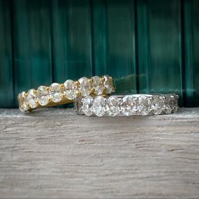 Shown here are oval cut diamonds set in either a white or a yellow gold band!