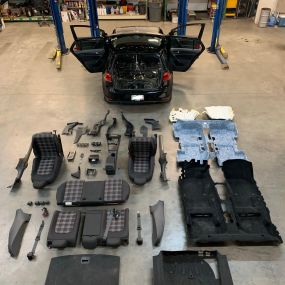 The interior of a 2017 Volkswagen GTI laid out for roll cage installation.