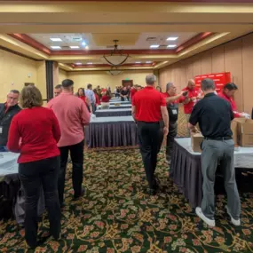 New Mexico State Farm Agents packing bags of personal hygiene products for Convoy of Hope. Call us today for a free auto quote!