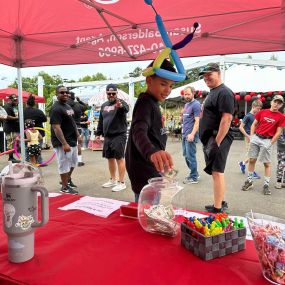 Stop by our booth today to get a balloon hat!