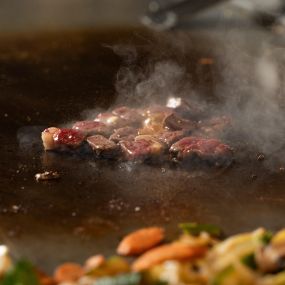 Steak Sizzling on Hot Hibachi Grill