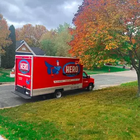 Hero: Plumbing, Heating, Cooling, Drains, Ducts & Electrical work truck  outside of a house