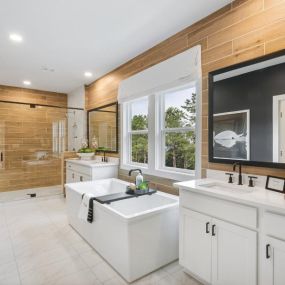 Spa-inspired primary baths with soaking tubs and spacious showers